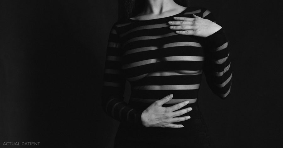 woman in a striped top and black pants posing for a picture